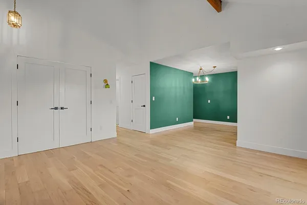 a view of an empty room with wooden floor