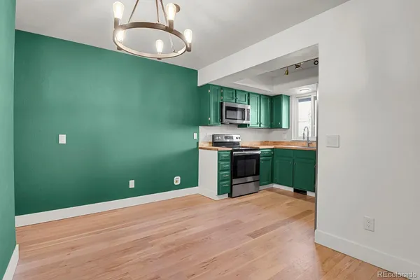 a kitchen with stainless steel appliances a refrigerator and microwave