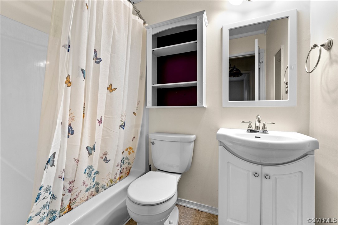10083 Burkes Pond Road North, VA 23128 - Photo 16 of 36 a bathroom with a sink a toilet and shower curtain