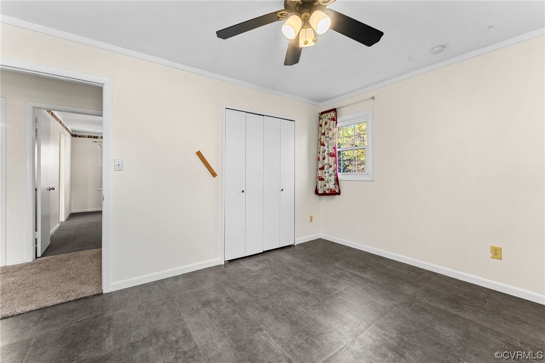 10083 Burkes Pond Road North, VA 23128 - Photo 21 of 36 an empty room with a chandelier fan and windows