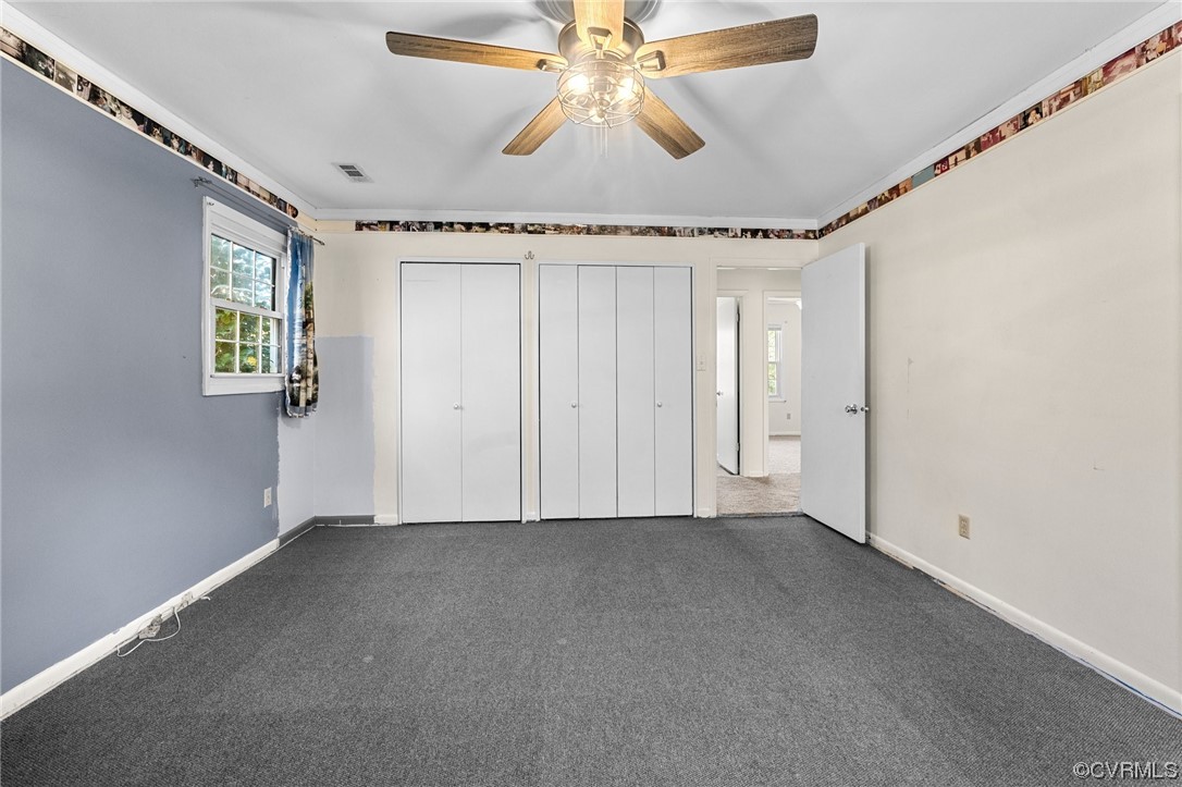 10083 Burkes Pond Road North, VA 23128 - Photo 25 of 36 an empty room with windows and fan