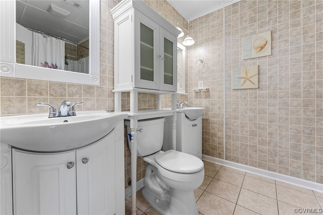 10083 Burkes Pond Road North, VA 23128 - Photo 26 of 36 a bathroom with a sink a toilet and shower