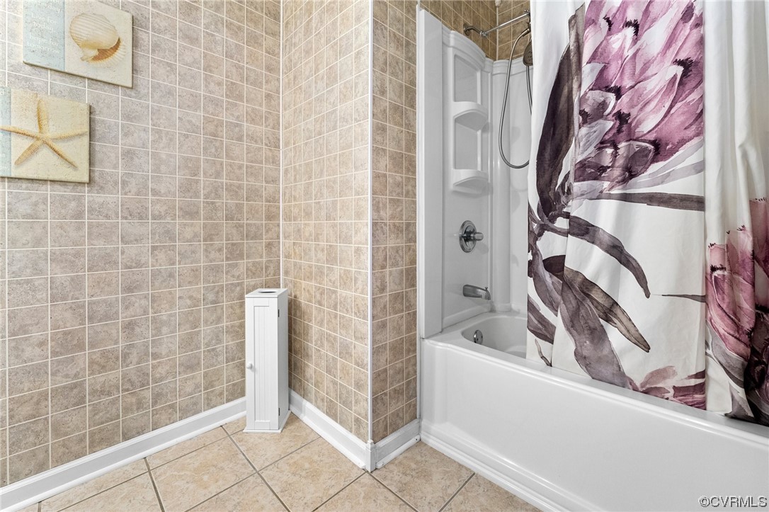 10083 Burkes Pond Road North, VA 23128 - Photo 27 of 36 a bathroom with a bathtub and shower