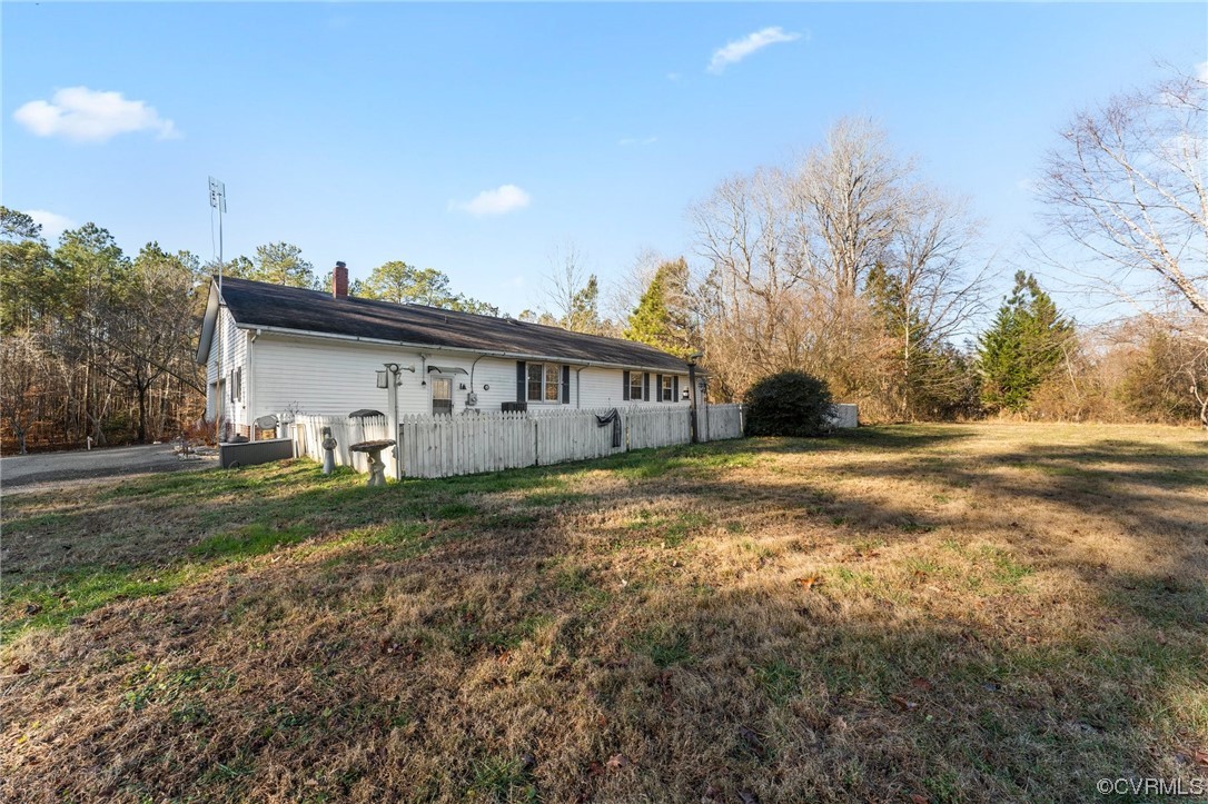 10083 Burkes Pond Road North, VA 23128 - Photo 29 of 36 a view of a house with a yard