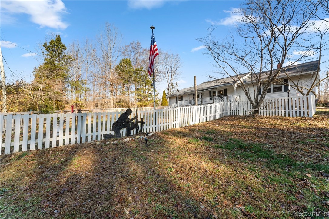10083 Burkes Pond Road North, VA 23128 - Photo 34 of 36 a front view of a house with a garden