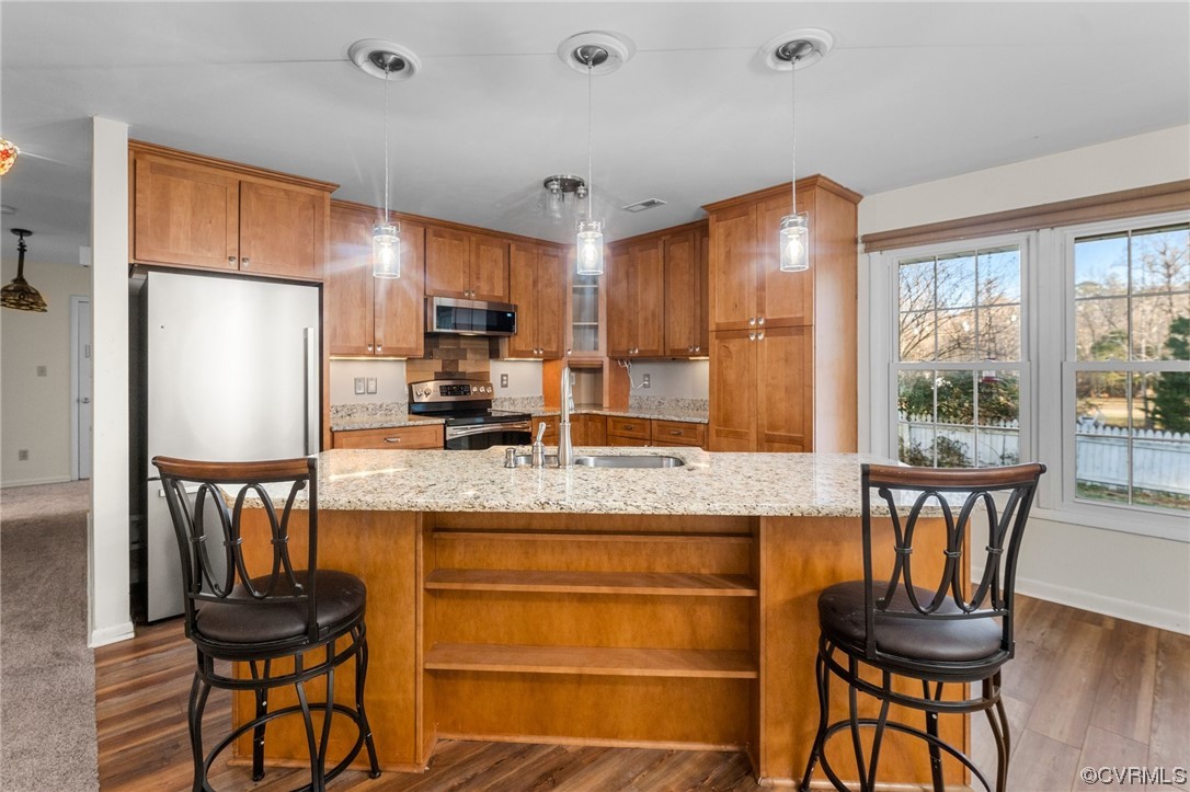 10083 Burkes Pond Road North, VA 23128 - Photo 6 of 36 a kitchen with granite countertop wooden floor dining table and chairs