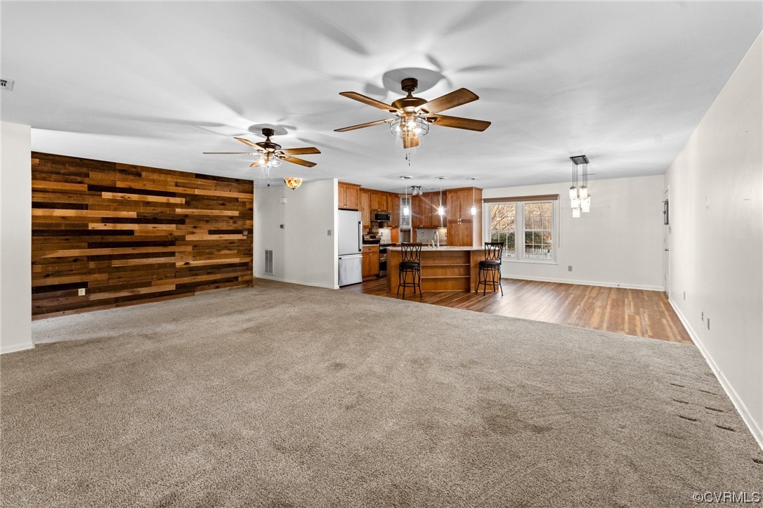10083 Burkes Pond Road North, VA 23128 - Photo 7 of 36 a view of empty room with wooden floor and fan