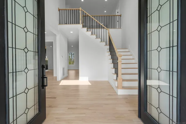 a view of entryway and hall with wooden floor