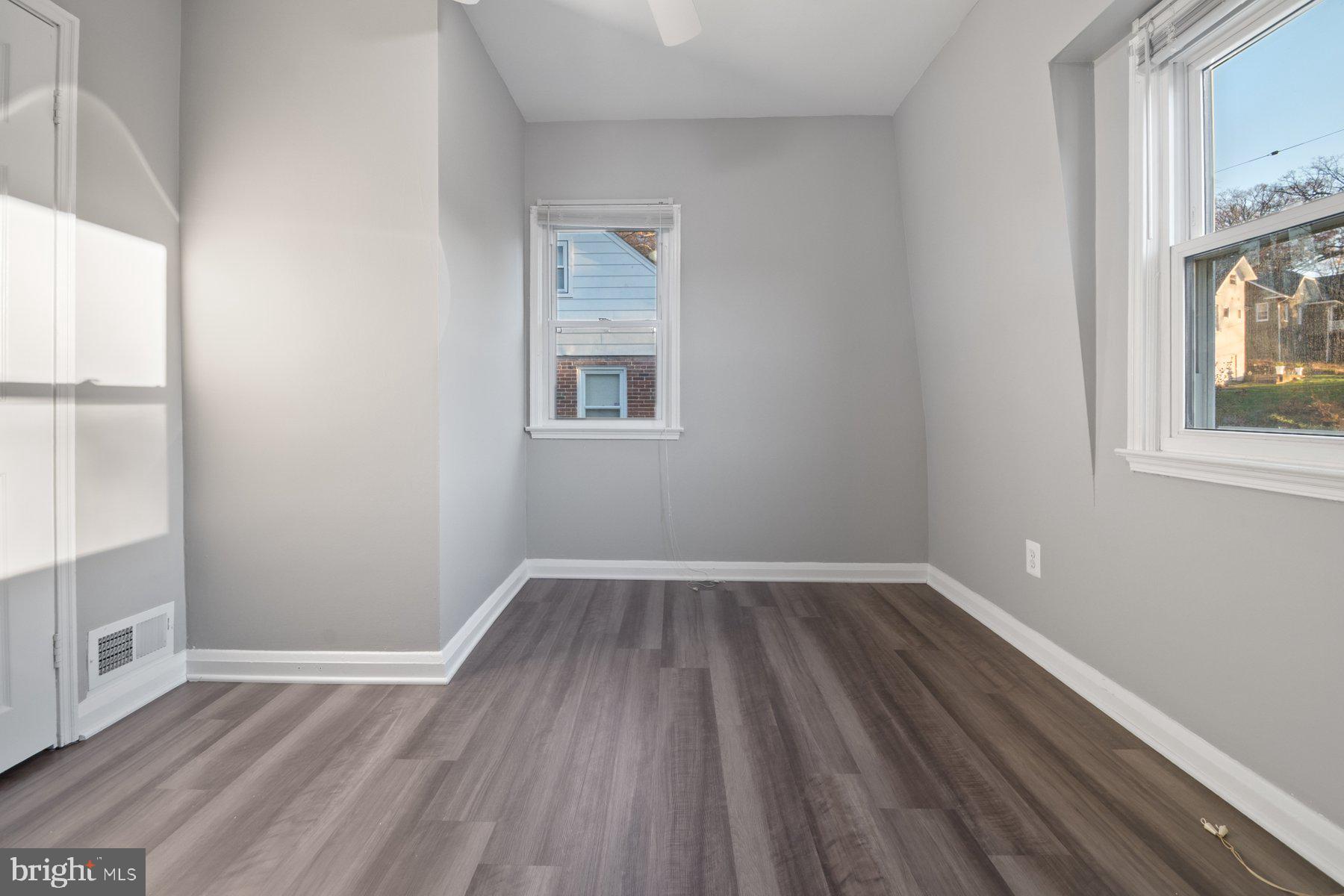2909 Lawina Road Baltimore, MD 21216 - Photo 17 of 24 an empty room with wooden floor and windows