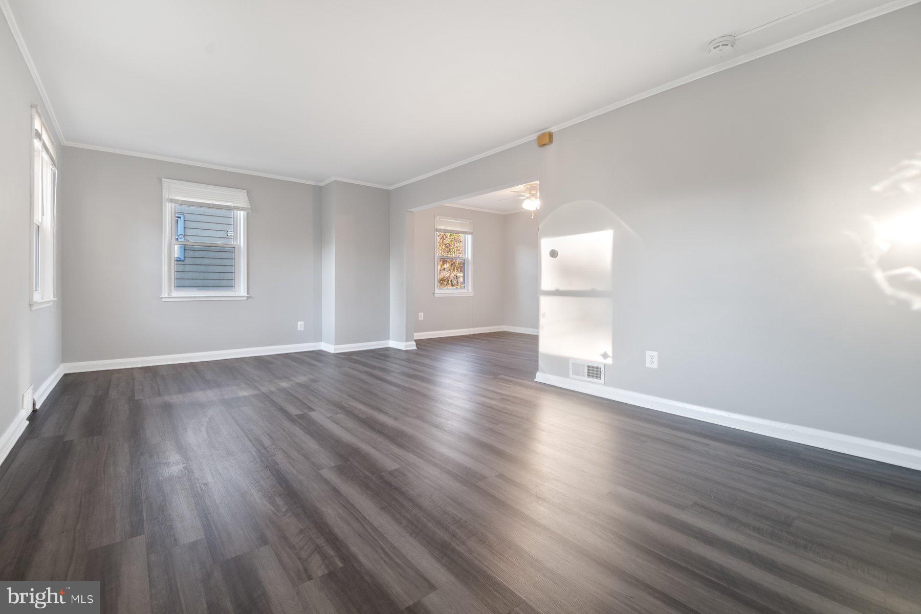2909 Lawina Road Baltimore, MD 21216 - Photo 3 of 24 a view of empty room with wooden floor and window