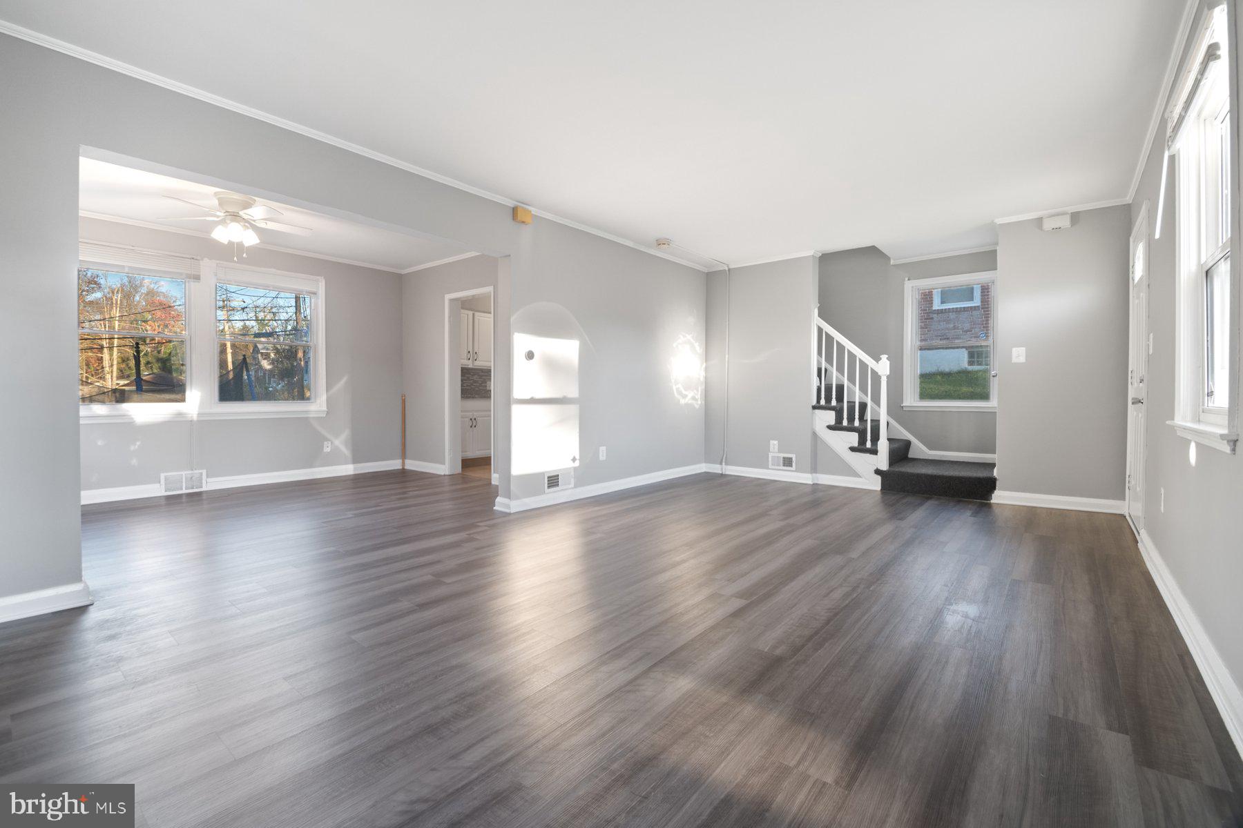 2909 Lawina Road Baltimore, MD 21216 - Photo 4 of 24 a view of an empty room with wooden floor and a window