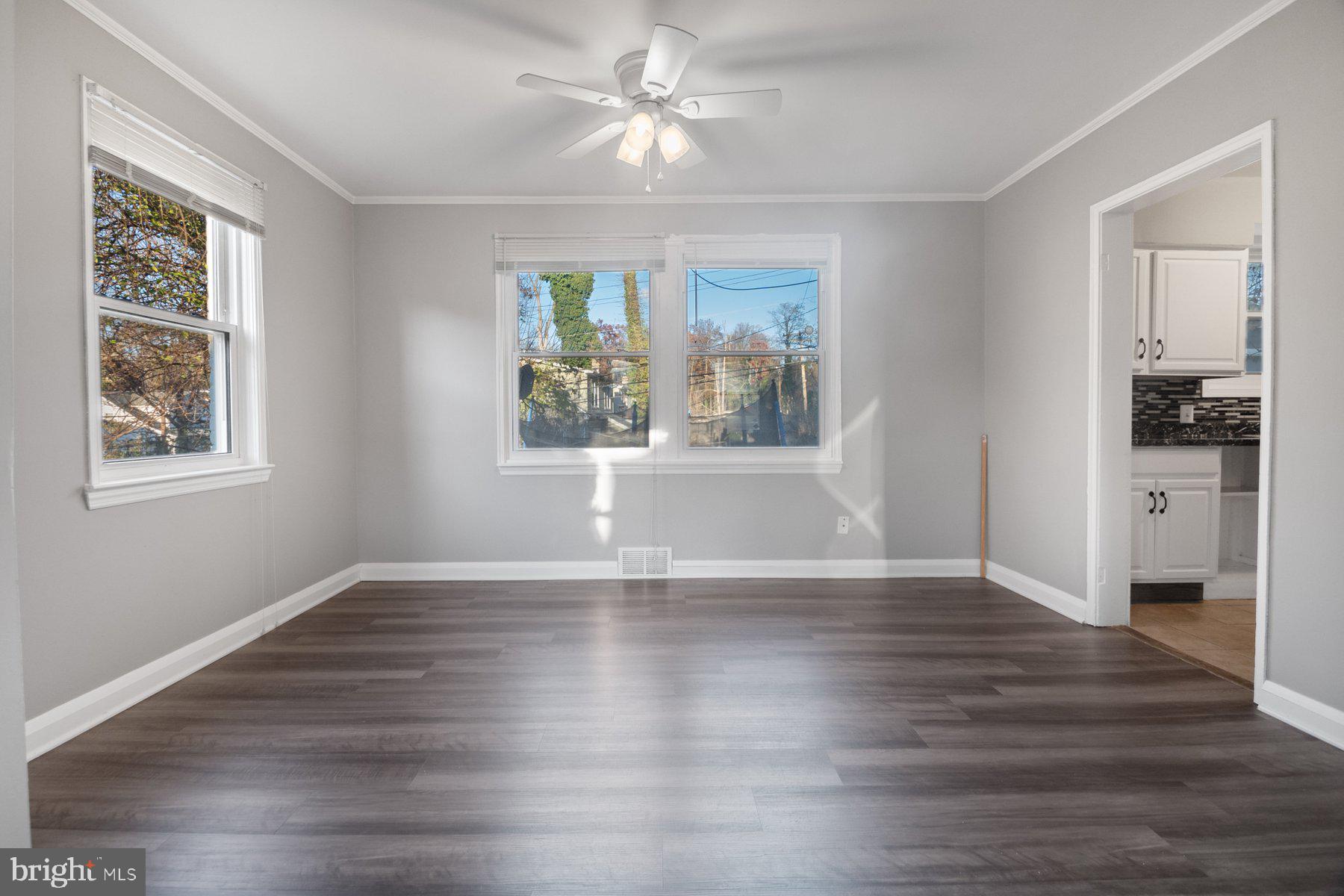 2909 Lawina Road Baltimore, MD 21216 - Photo 5 of 24 a view of an empty room with a window and wooden floor