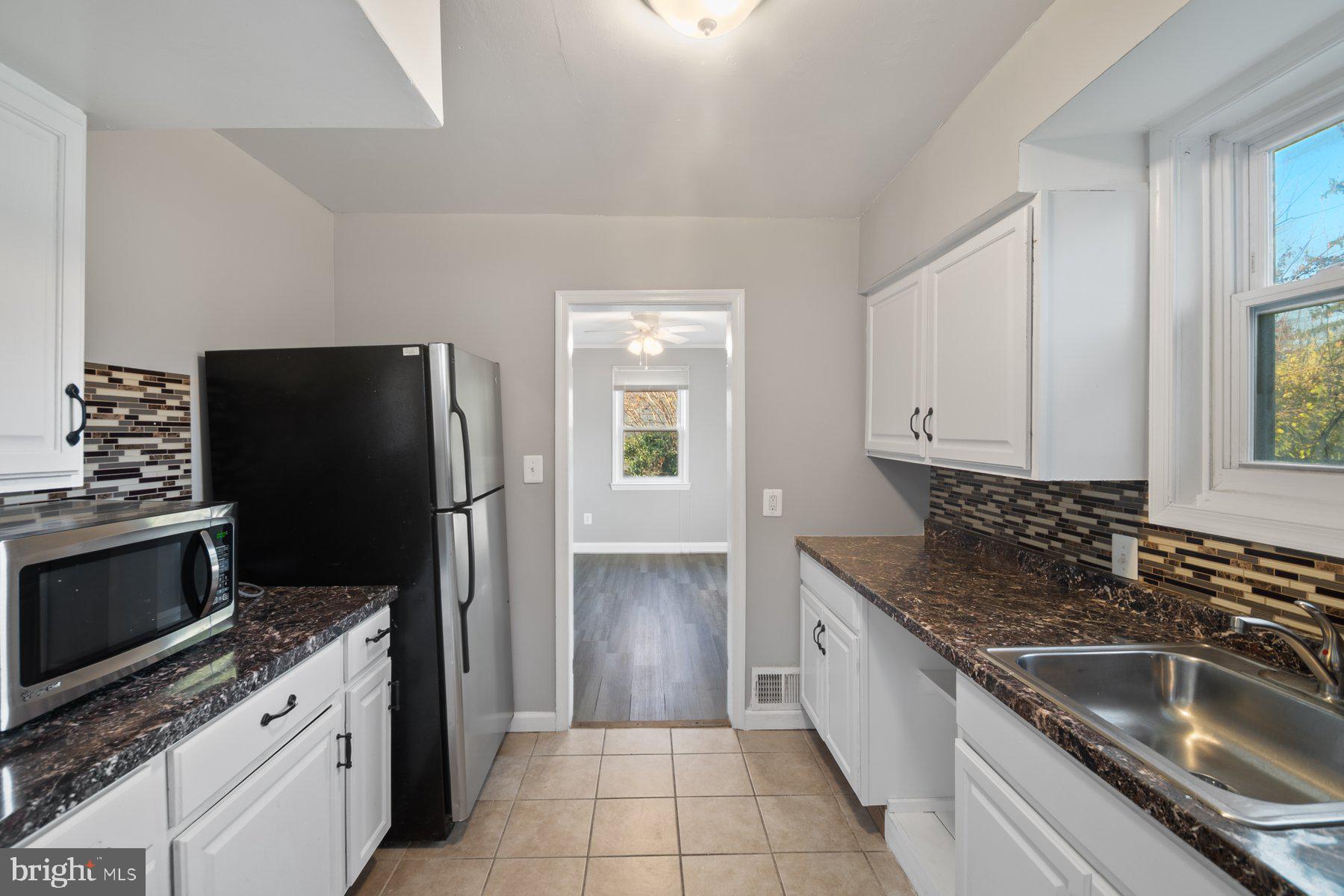 2909 Lawina Road Baltimore, MD 21216 - Photo 8 of 24 a kitchen with a sink stove and refrigerator