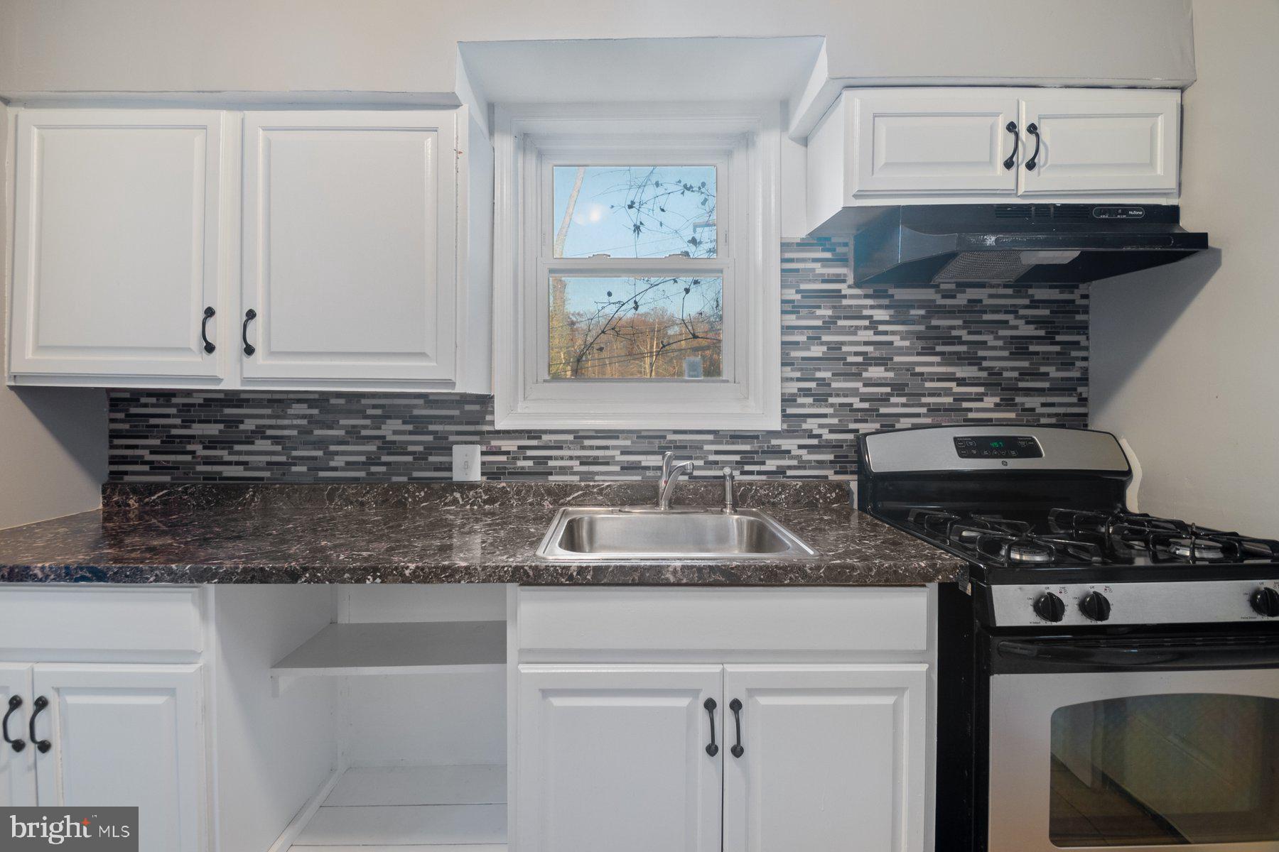 2909 Lawina Road Baltimore, MD 21216 - Photo 9 of 24 a kitchen with stainless steel appliances granite countertop a sink stove and cabinets