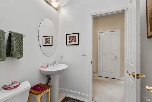 a bathroom with a sink mirror and toilet
