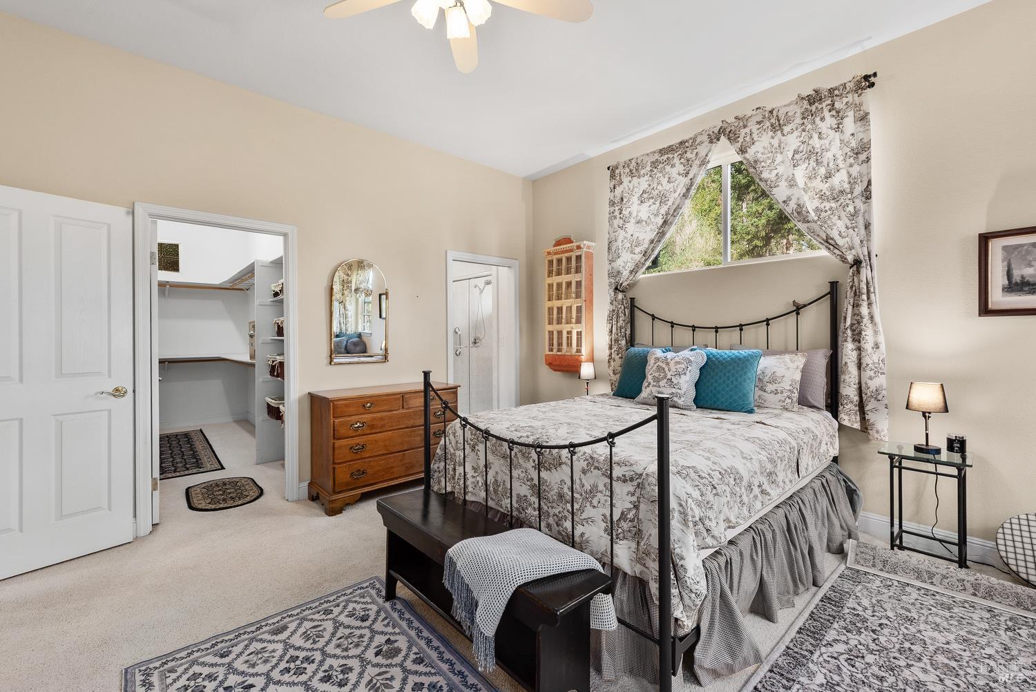 1885 Los Olivos Road Santa Rosa, CA 95404 - Photo 22 of 47 a bedroom with a bed a chandelier and dresser