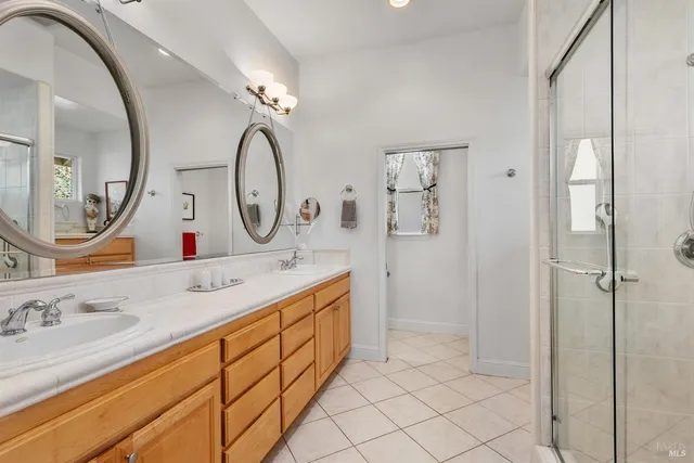 a bathroom with a double vanity sink mirror and a