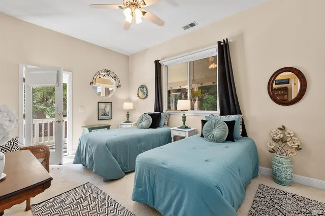 a bedroom with two beds and a large window