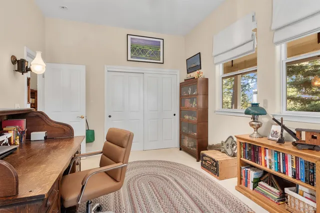 a bedroom with furniture and a book shelf