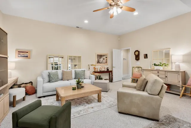 a living room with furniture and view of kitchen