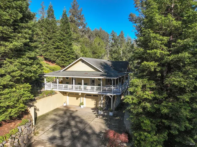 an aerial view of a house with a yard table and chairs