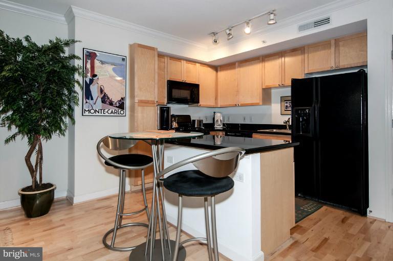 a kitchen with stainless steel appliances kitchen island a refrigerator and a stove