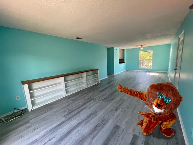 a view of a room with wooden floor