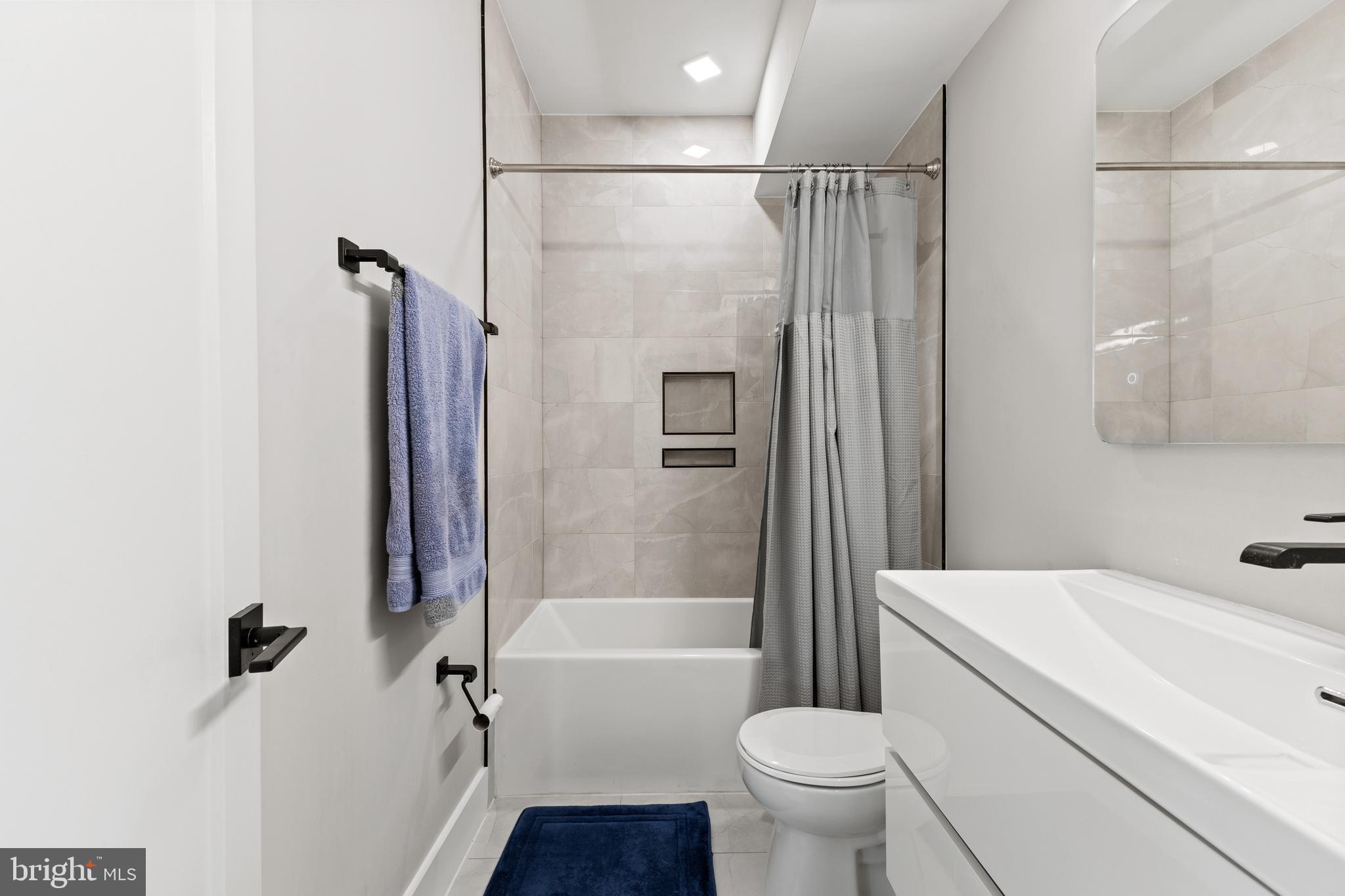 1028 Bladensburg Road Northeast, Unit 37 Washington, DC 20002 - Photo 16 of 29 a bathroom with a sink toilet and shower