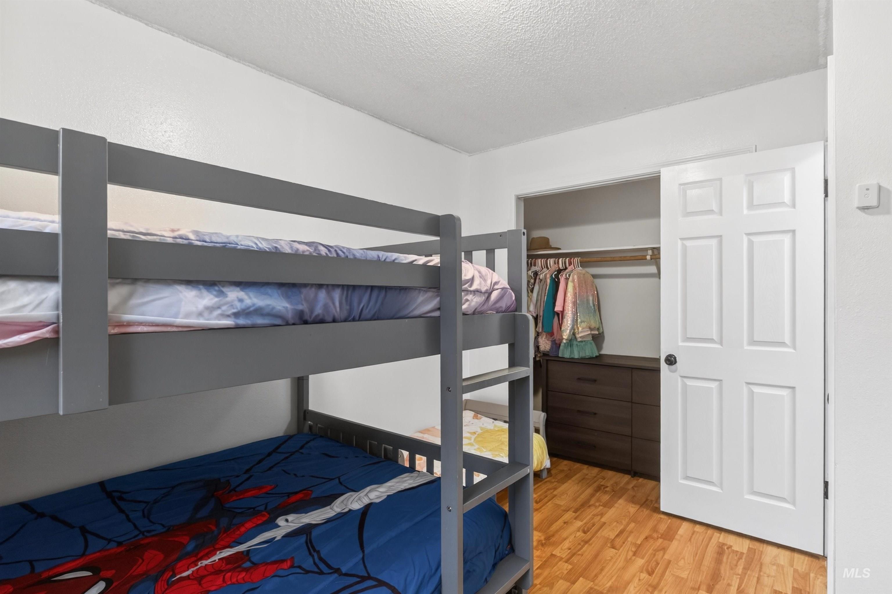 247 North Beech Street Genesee, ID 83832 - Photo 17 of 27 Bright room featuring light wood-finish flooring, white walls, and a white six-panel door with black hardware