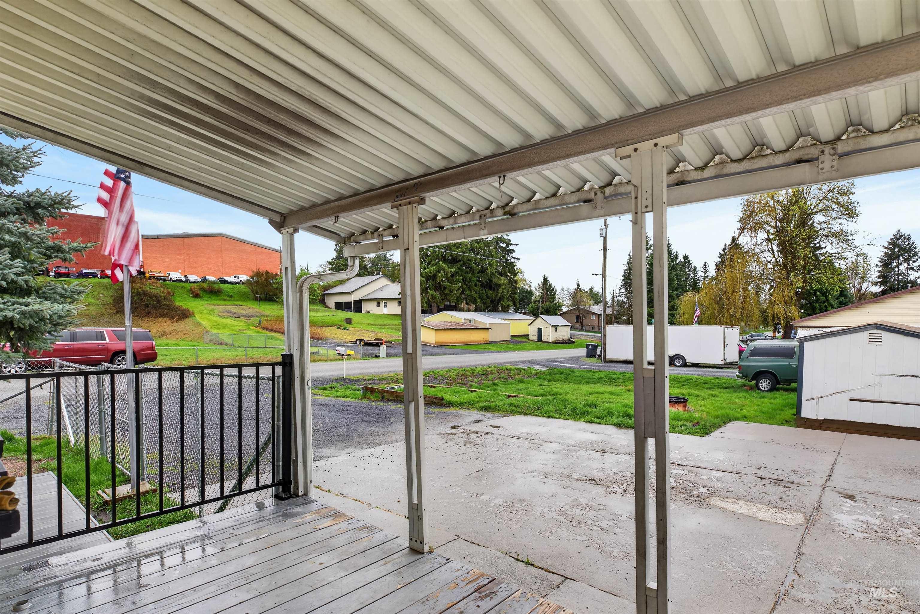 247 North Beech Street Genesee, ID 83832 - Photo 26 of 27 Covered patio area with wood-finish decking and black metal railings