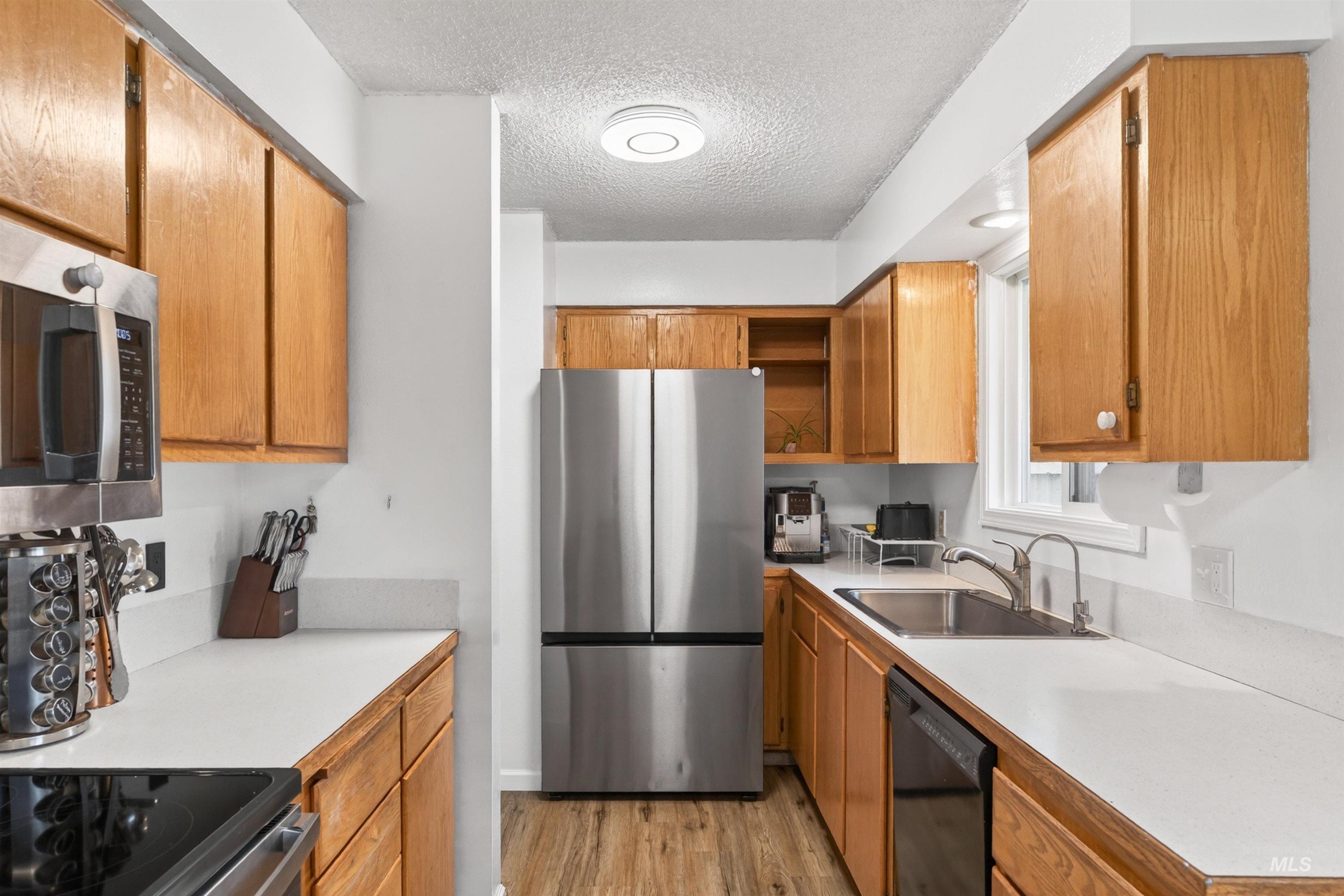247 North Beech Street Genesee, ID 83832 - Photo 6 of 27 Galley kitchen featuring light wood cabinetry and light countertops