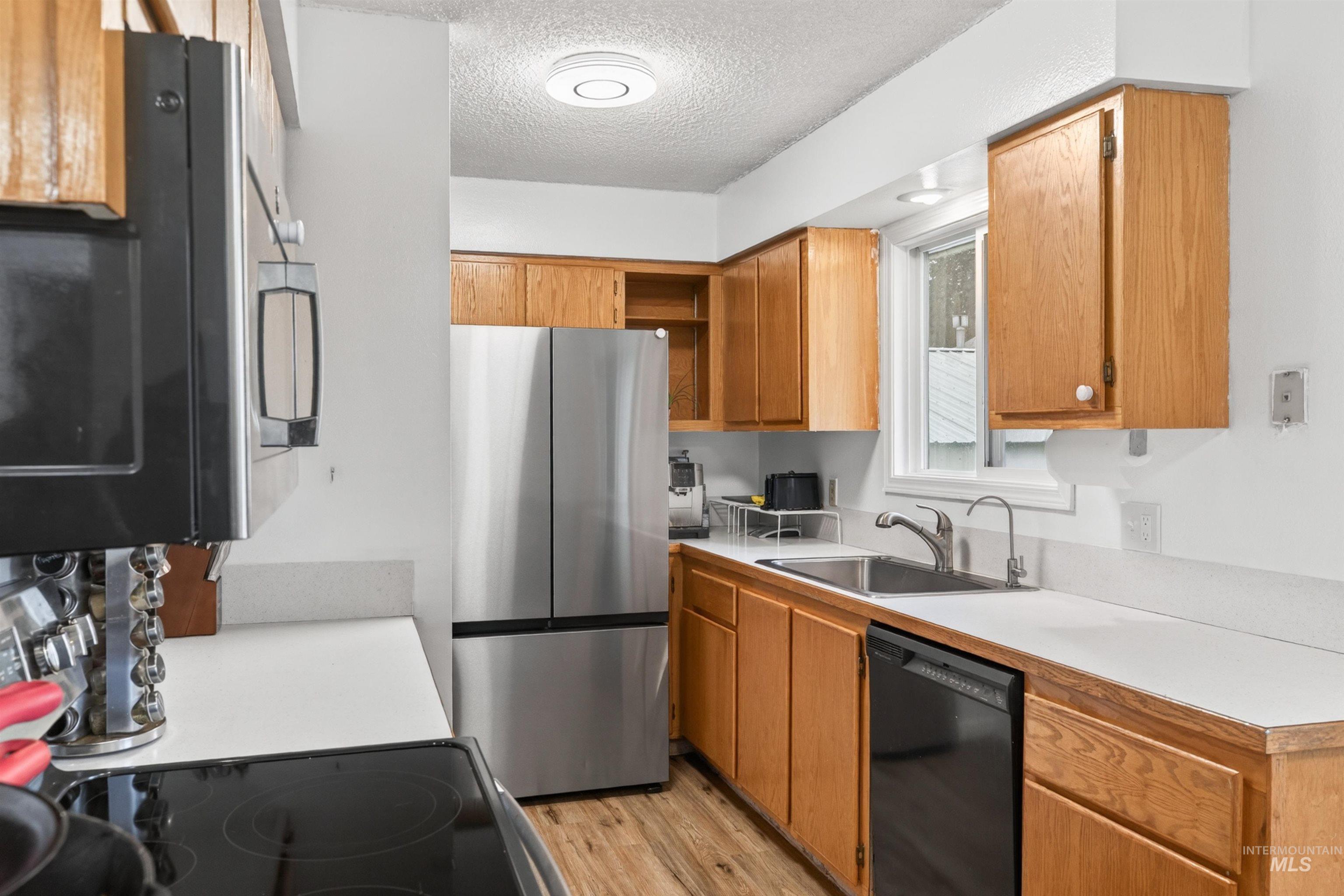 247 North Beech Street Genesee, ID 83832 - Photo 8 of 27 Kitchen featuring wood-finish cabinetry, white countertops, and stainless steel appliances