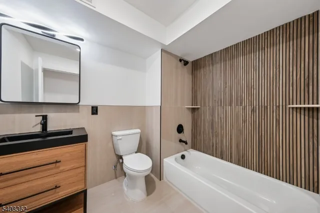 a bathroom with a toilet a sink and bathtub