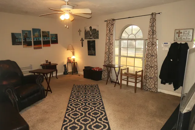 a living room with furniture and a large window