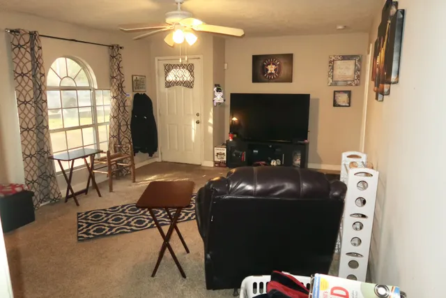 a living room with furniture and a flat screen tv