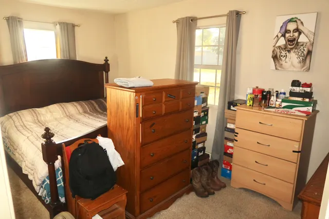 a bedroom with a bed and a window