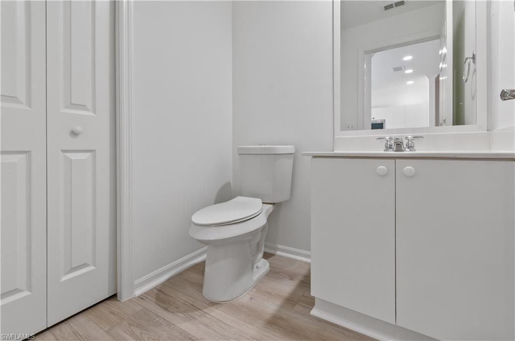 3281 Lindsey Lane, Unit 55 Naples, FL 34109 - Photo 14 of 43 a bathroom with a toilet and a mirror
