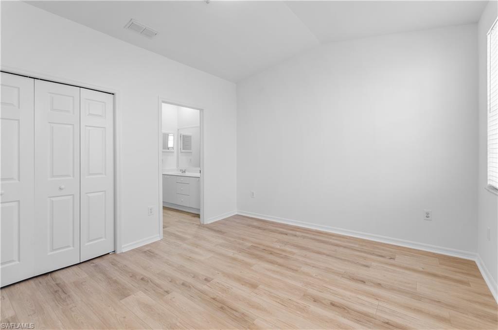 3281 Lindsey Lane, Unit 55 Naples, FL 34109 - Photo 16 of 43 a view of an empty room with wooden floor