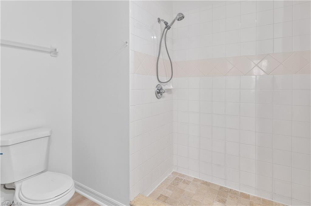 3281 Lindsey Lane, Unit 55 Naples, FL 34109 - Photo 18 of 43 a bathroom with a shower and toilet