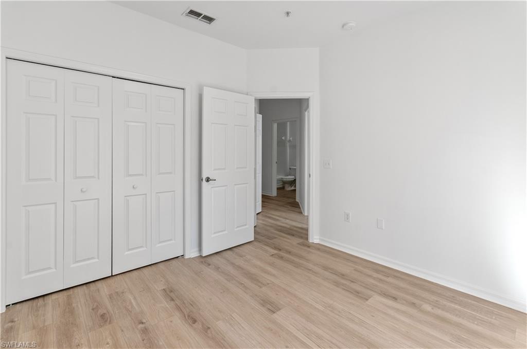 3281 Lindsey Lane, Unit 55 Naples, FL 34109 - Photo 21 of 43 a view of a livingroom with wooden floor
