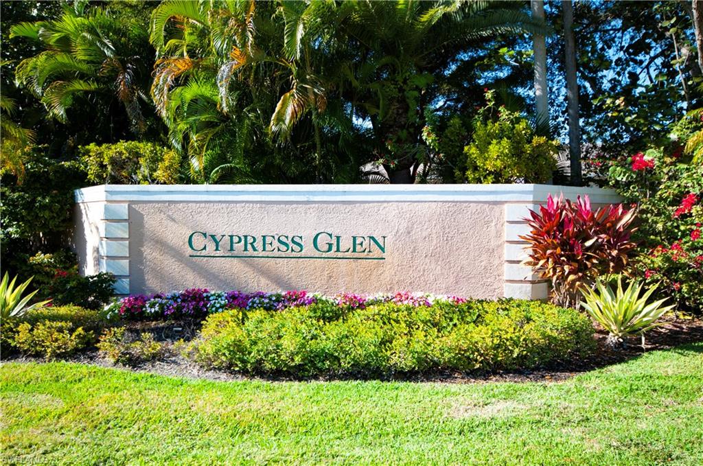 3281 Lindsey Lane, Unit 55 Naples, FL 34109 - Photo 29 of 43 a sign that is in front of flowers