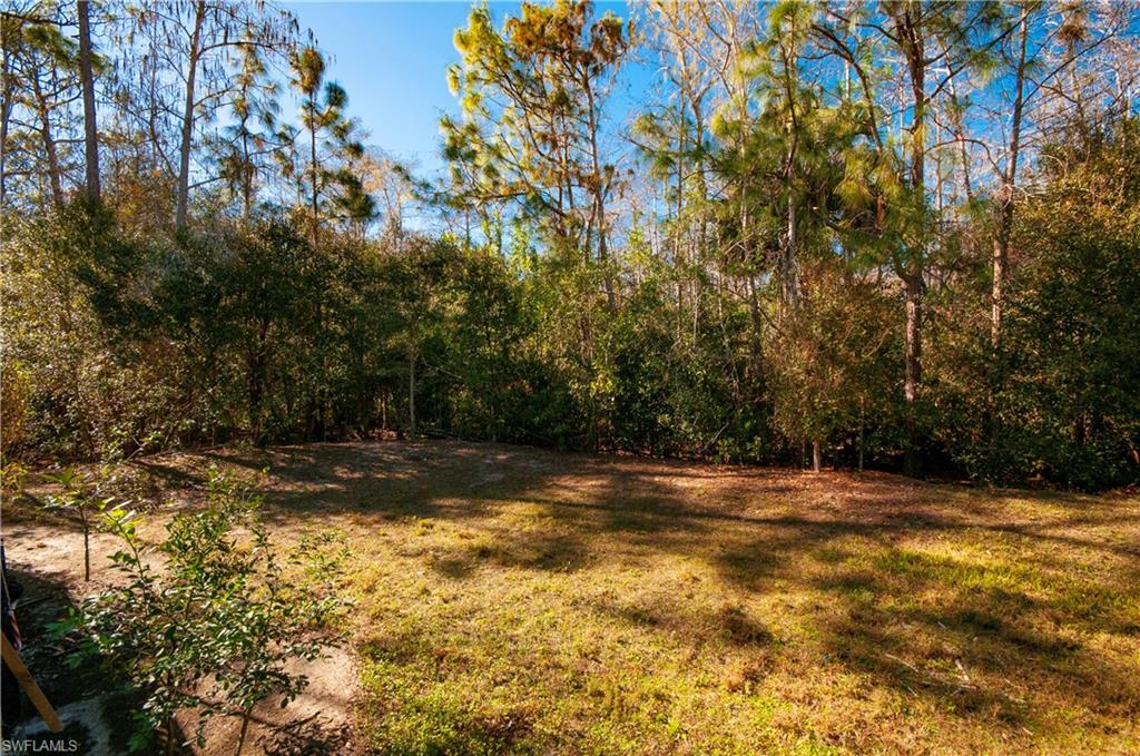 3281 Lindsey Lane, Unit 55 Naples, FL 34109 - Photo 35 of 43 a view of a yard with trees