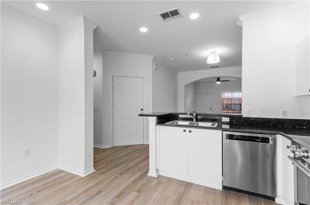 3281 Lindsey Lane, Unit 55 Naples, FL 34109 - Photo 5 of 43 a kitchen with stainless steel appliances granite countertop a stove and a sink