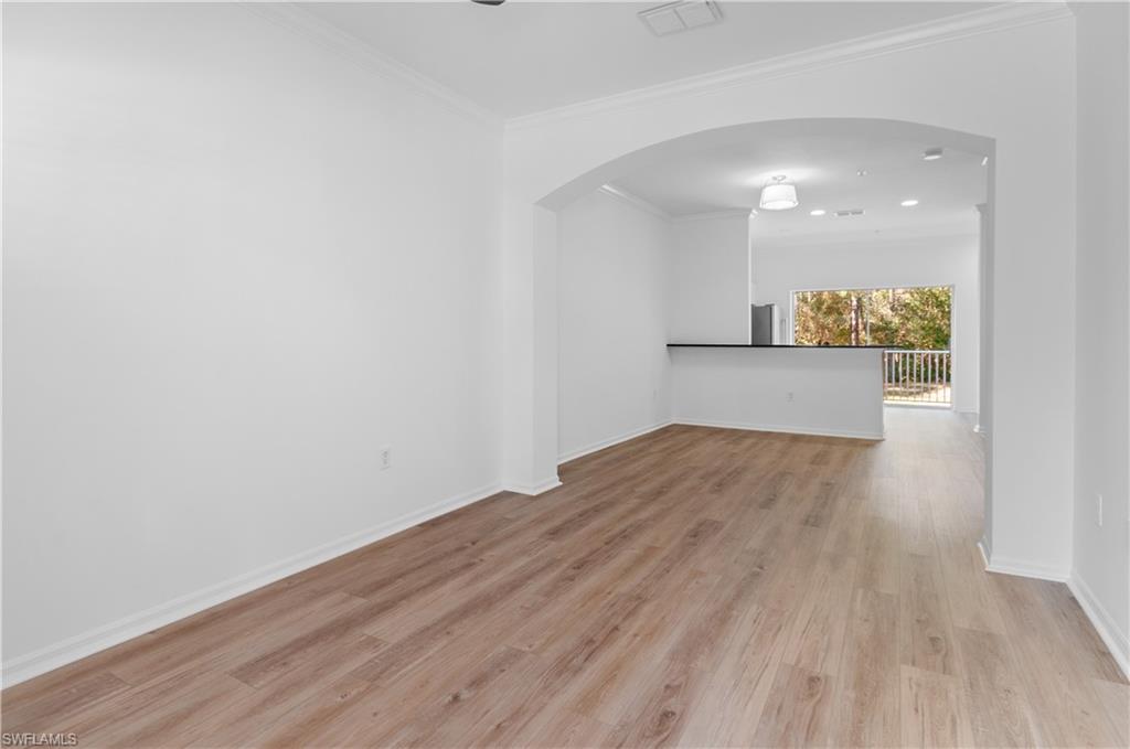 3281 Lindsey Lane, Unit 55 Naples, FL 34109 - Photo 8 of 43 a view of empty room with wooden floor
