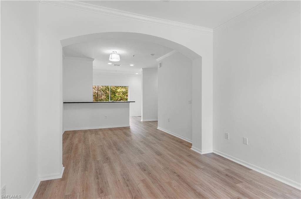 3281 Lindsey Lane, Unit 55 Naples, FL 34109 - Photo 9 of 43 a view of a room with wooden floor