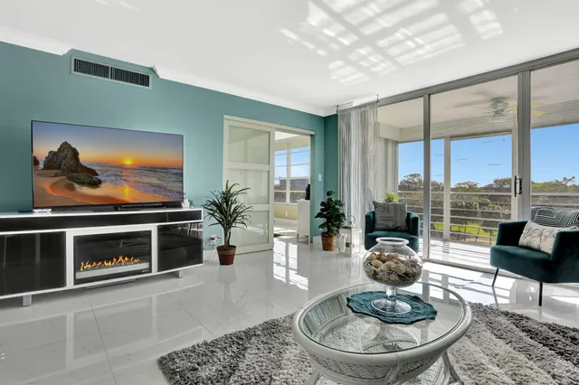 a bathroom with a granite countertop sink toilet and mirror