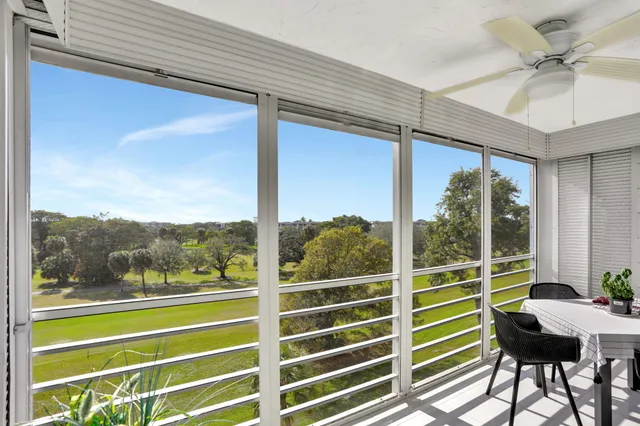 a living room with furniture a flat screen tv and a potted plant