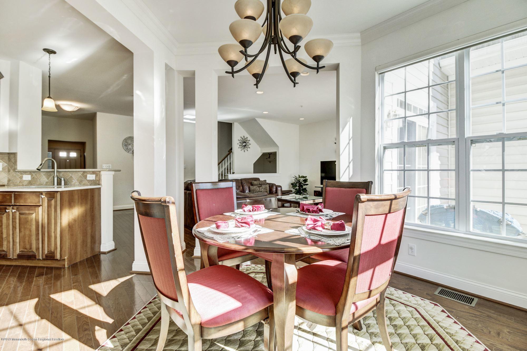 1006 Abby Road Middletown, NJ 07748 - Photo 16 of 44 a view of a dining room with furniture window and wooden floor