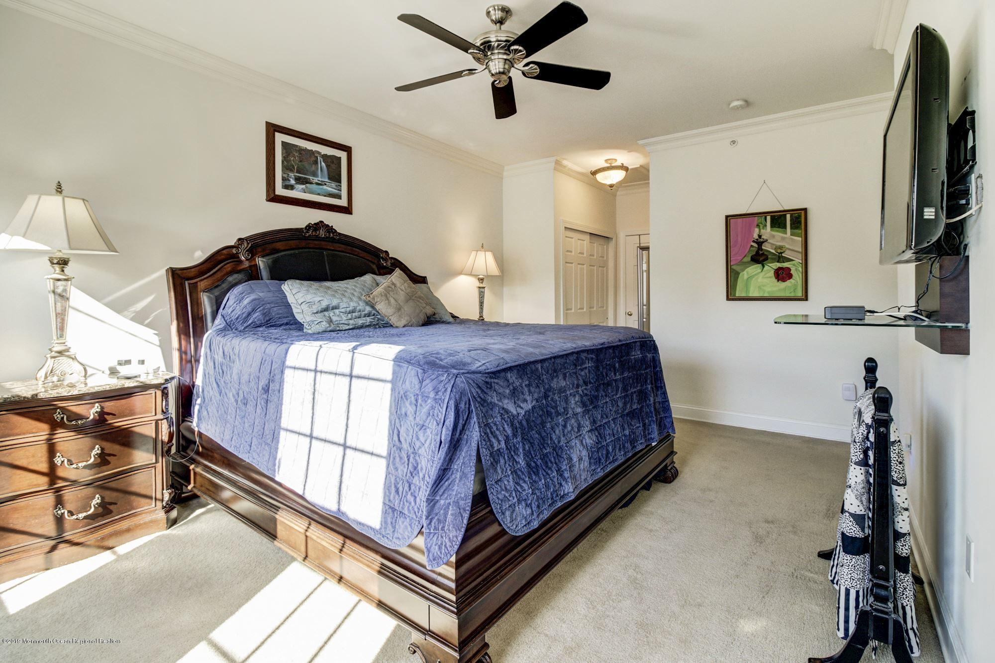 1006 Abby Road Middletown, NJ 07748 - Photo 24 of 44 a bedroom with a bed and a flat screen tv