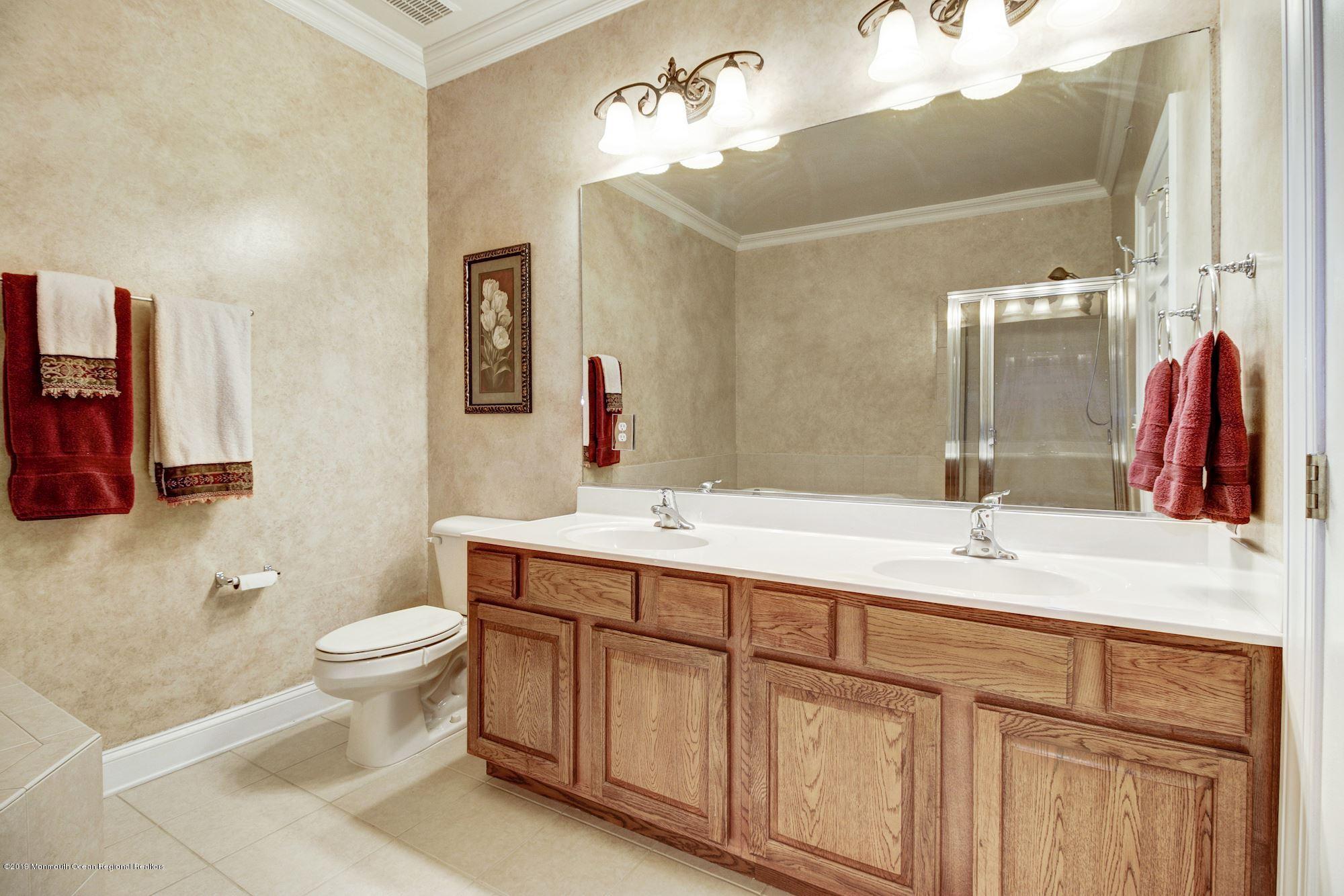 1006 Abby Road Middletown, NJ 07748 - Photo 26 of 44 a bathroom with a double vanity sink and a mirror